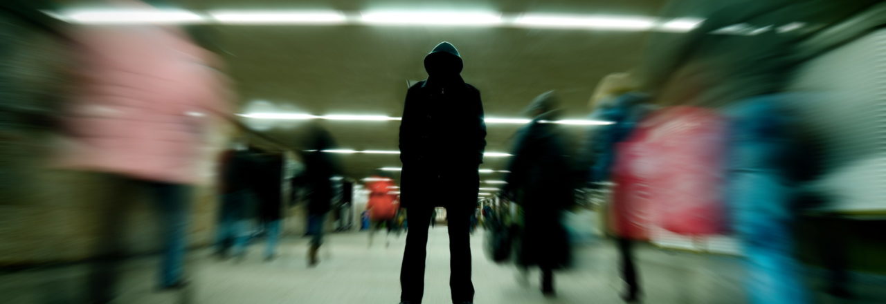 Black silhouette standing in crowd